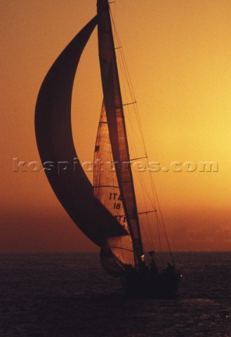 Racing yacht sailing into the sunset