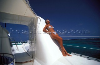 Blue Water Cruising. Model girl onboard luxury catamaran