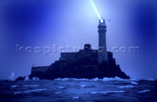 Fastnet Rock Lighthouse with light in a storm