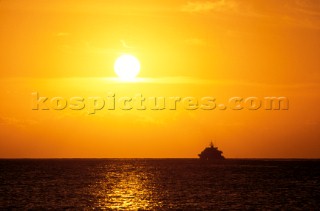 Superyacht on horizon at sunset