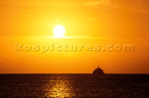 Superyacht on horizon at sunset