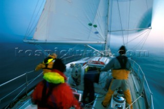 Crew onboard BT Challenge boat sailing at night