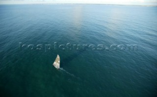 Aerial view of Open 60 sailing on calm sea