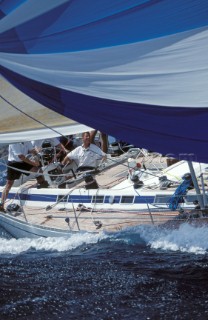 Crew member on Swan yacht under spinnaker