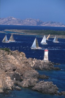 Fleet of Swan yachts racing through the Maddalena Islands off Port Cervo Sardinia during the Rolex Swan World Cup