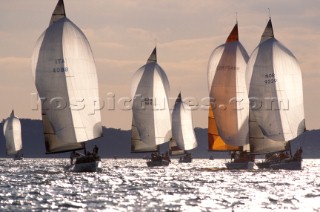 Fleet spinnaker run at sunset Farr 40Õs in the Solent