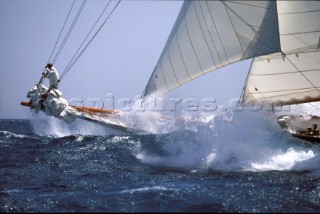 Bow of large classic pounds through the waves