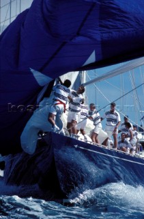 Crew on maxi yacht struggle to bring down a huge spinnaker