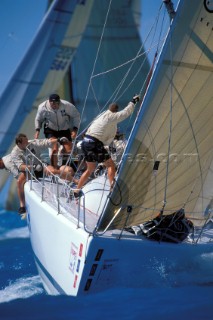 Crew preparing to hoist spinnaker approaching windward mark SORC