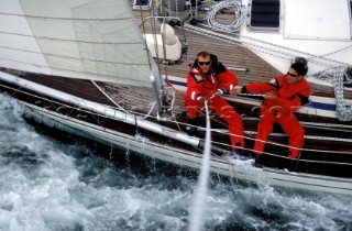 Aerial view of crew member pulling in spinnaker