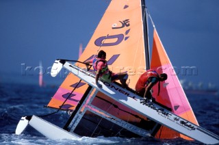 Crew on a Hobie 16 hang on after they nose dive into the water