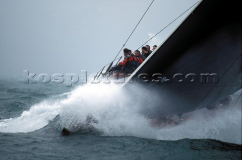 Bow of maxi racing yacht Stealth crashes through a wave in poor conditions