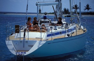 Girls relaxing on the deck of a Swan 55 at anchor by Sandy Island in the Caribbean