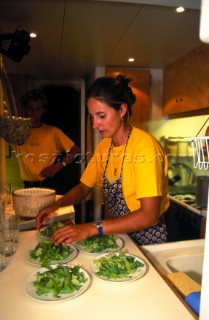 Cook onboard a yacht prepares a meal for charter guests