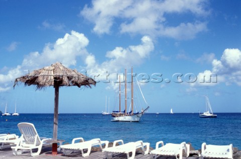 Classic schooner anchored off beach resort in Martinique Caribbean