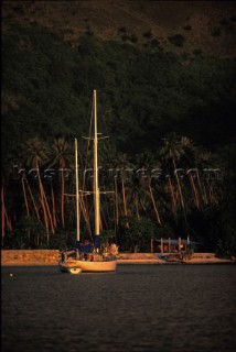 Yacht anchored in bay at sunset, Polynesia