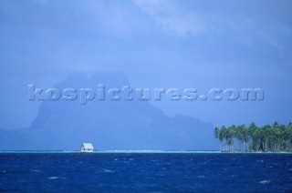 Hut on stilts in shallow water, French Polynesia