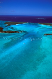 Bright turquoise blue water in the sandy bays and reefs and shoals of the best cruising areas of New Caledonia