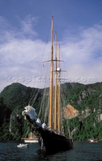 Cruising yachts anchored in a secluded bay off the coast of Phuket in Thailand