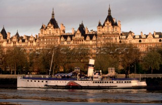 Grand architecture and the paddle steamer Tattershall Castle on the banks of the river Thames, London