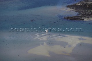 Yacht at low tide. Scilly Isles UK