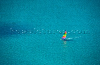 Ariel shot of a dinghy in crystal clear shallow water