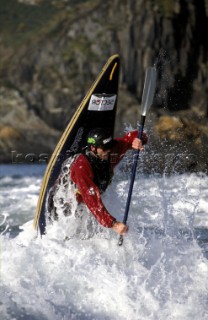 Canoeist lands with a splash in fast flowing river