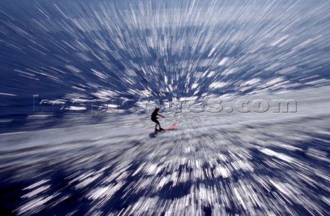 Zoom burst effect on aerial view of waterskier