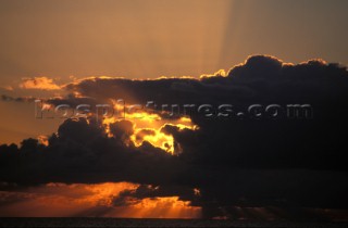 Suns rays shining through dark cloud