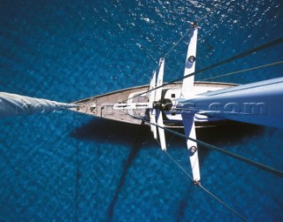 Aerail view of deck of yacht from masthead in clear blue water