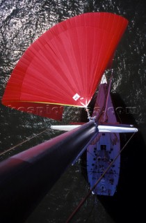 Masthead shot from the top of the mast of the red spinnaker and pole of the Volvo Whitbread 60 racing yacht Winston Team Dennis Conner