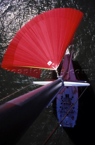 Masthead shot from the top of the mast of the red spinnaker and pole of the Volvo Whitbread 60 racin