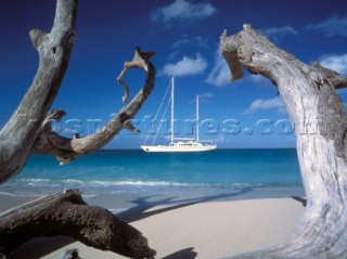 Superyacht anchored off sandy beach