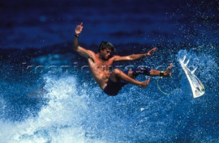 A surfer wipes out and falls from his board