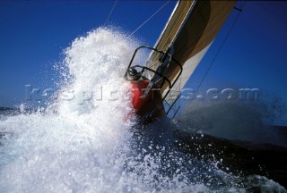 Close up of bow of Volvo 60 Winston as she crashes into a large wave at speed