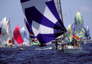 Colourful spinnakers of fleet racing at Antigua Sailing Week