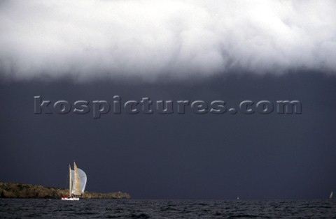 Yacht sailing under stormy sky