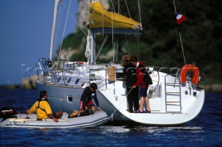 People leaving a crusing yacht to go ashore for dinner