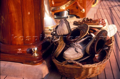 Basket of deck shoes on a classic yacht