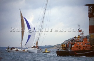 Seastart and the Yarmouth Arun 52 RNLI lifboat standing by as the Beneteau Spirit of the North crashes into Goose Rock whilst under spinnaker, alongside the maxi Longobarda which is already aground next to the Needles lighthouse