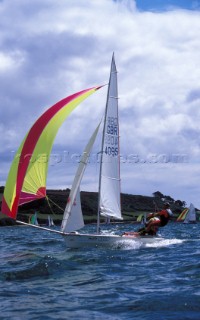 Two sailors on a Laser 4000 sail down wind under spinnaker