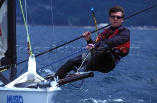 Dinghy sailor hiking out on a trapeze