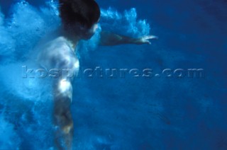 Man diving into clear water