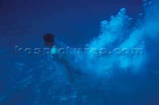 Man diving into clear water