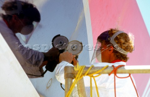 A shipyard worker repairs the hull of the Whibread 60 yacht Winston