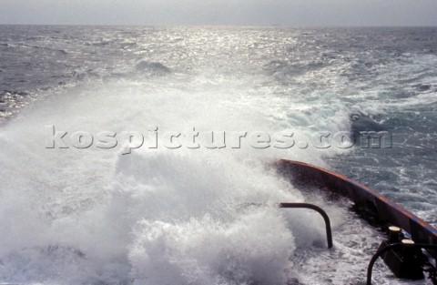 Stern of commercial tug boat ship in rough seas