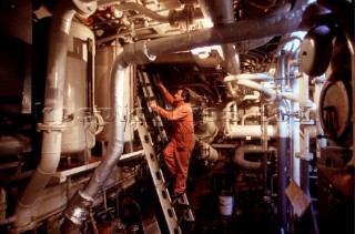 Man leaves the engine room of a tug boat