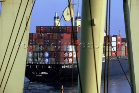 View of loaded container ship through crane