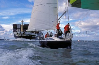 A yacht sails dangerously close to a container ship in restricted water