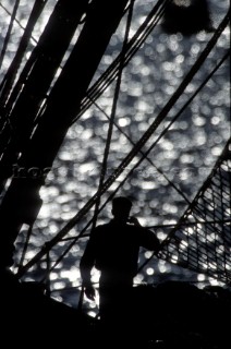 Silhouette on crew member on baord classic yacht